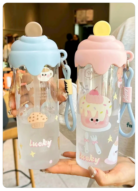 clear plastic water bottles with cute cartoon cupcake designs and pastel-colored lids, held in hands against an indoor background.