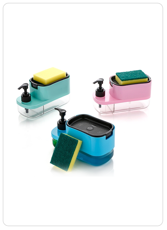 Three countertop soap dispensers in teal, pink, and blue, each with a sponge holder, soap dish, and pump dispenser, shown with cleaning sponges on a white background.